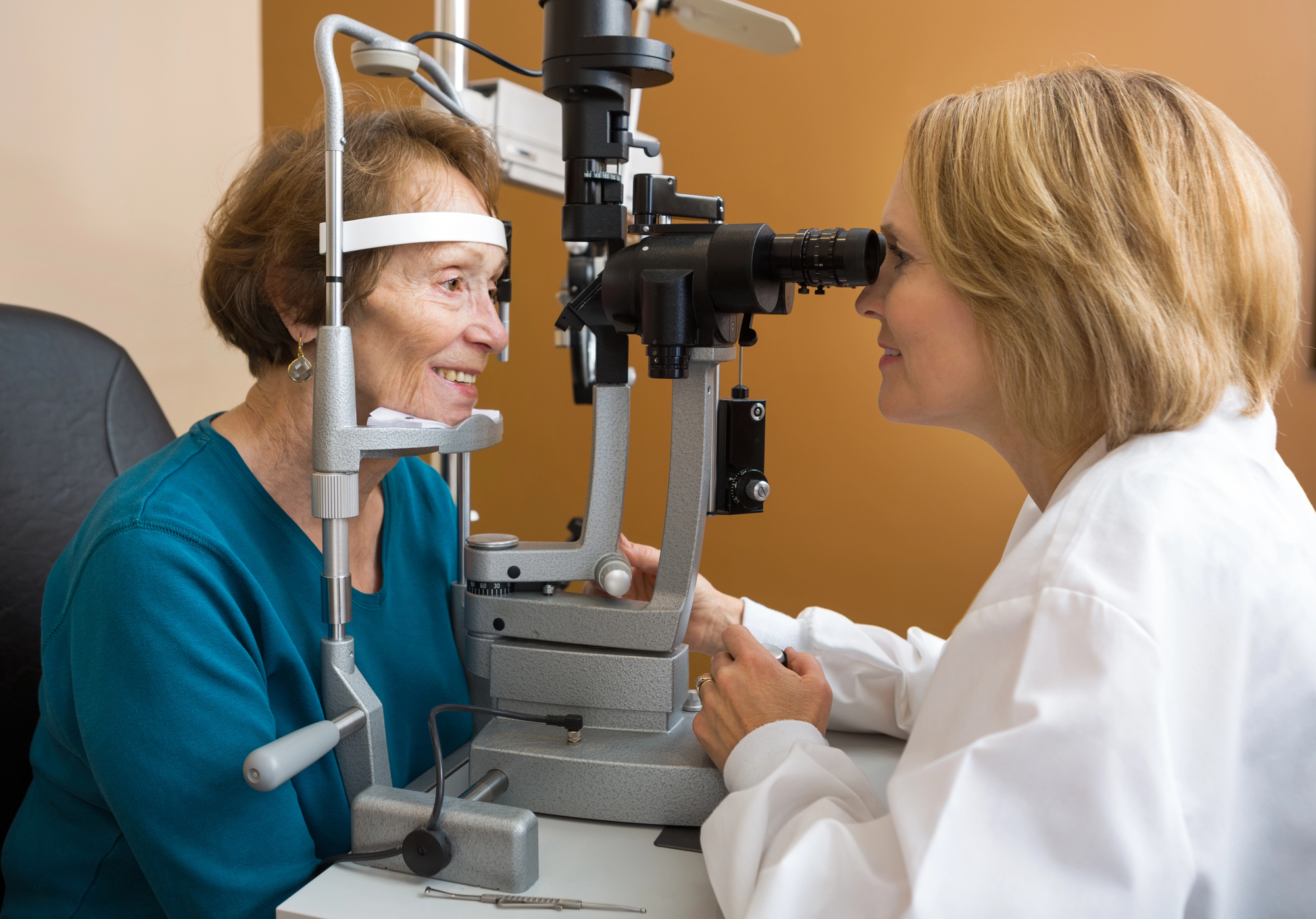 optician carrying out an eye test in a care home