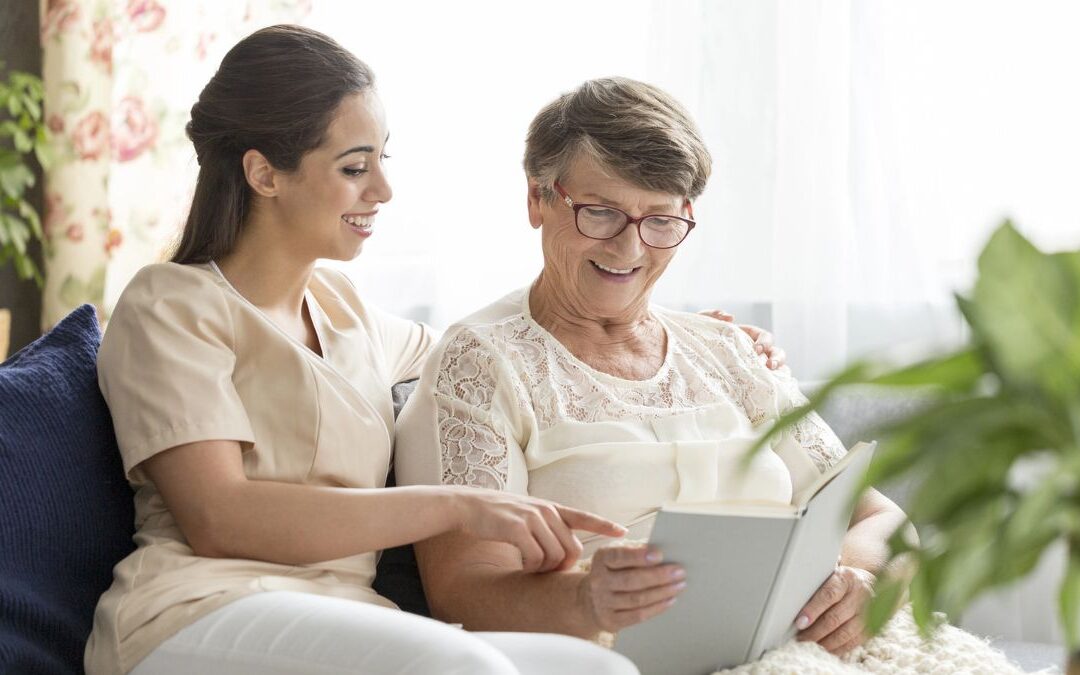 Elderly relative reading at home while family member observes